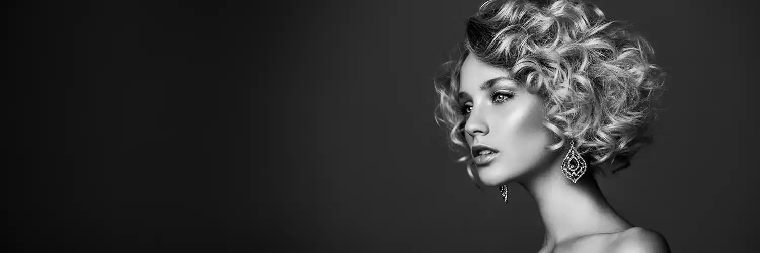 A dramatic black and white photo of a blonde lady with beautiful blond curly hair